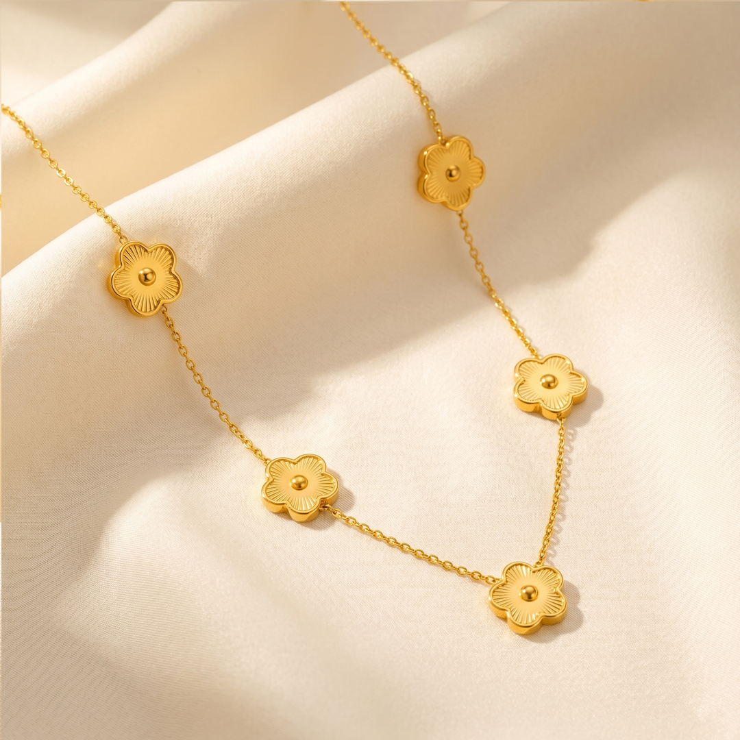 The clover flower necklace resting on cream silk