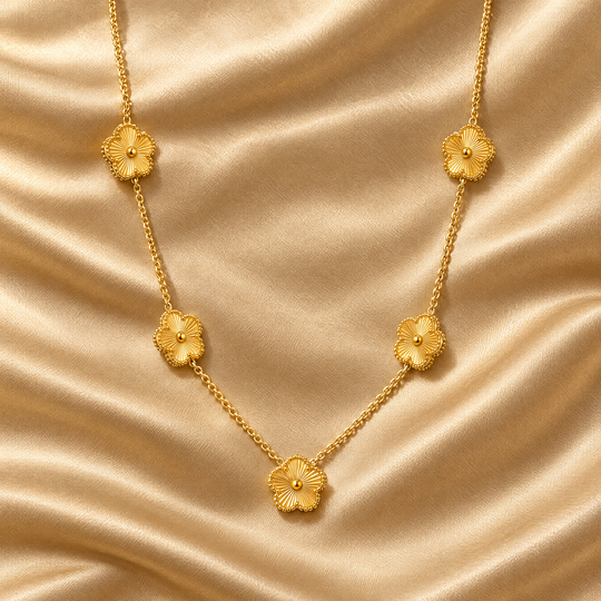 The Ava Bloom Necklace resting on champagne satin