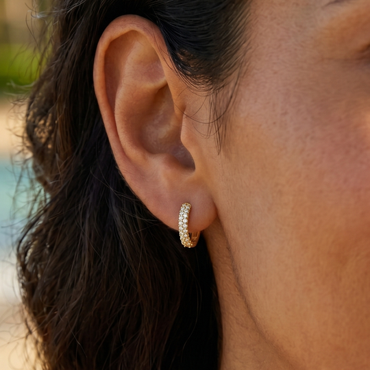 Close-up of the crystal huggie worn in the ear