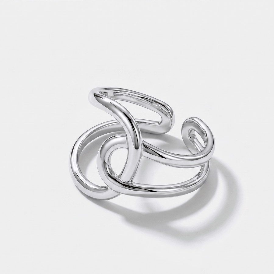A silver-tone open ring of two crossing, looping bands, on a plain background