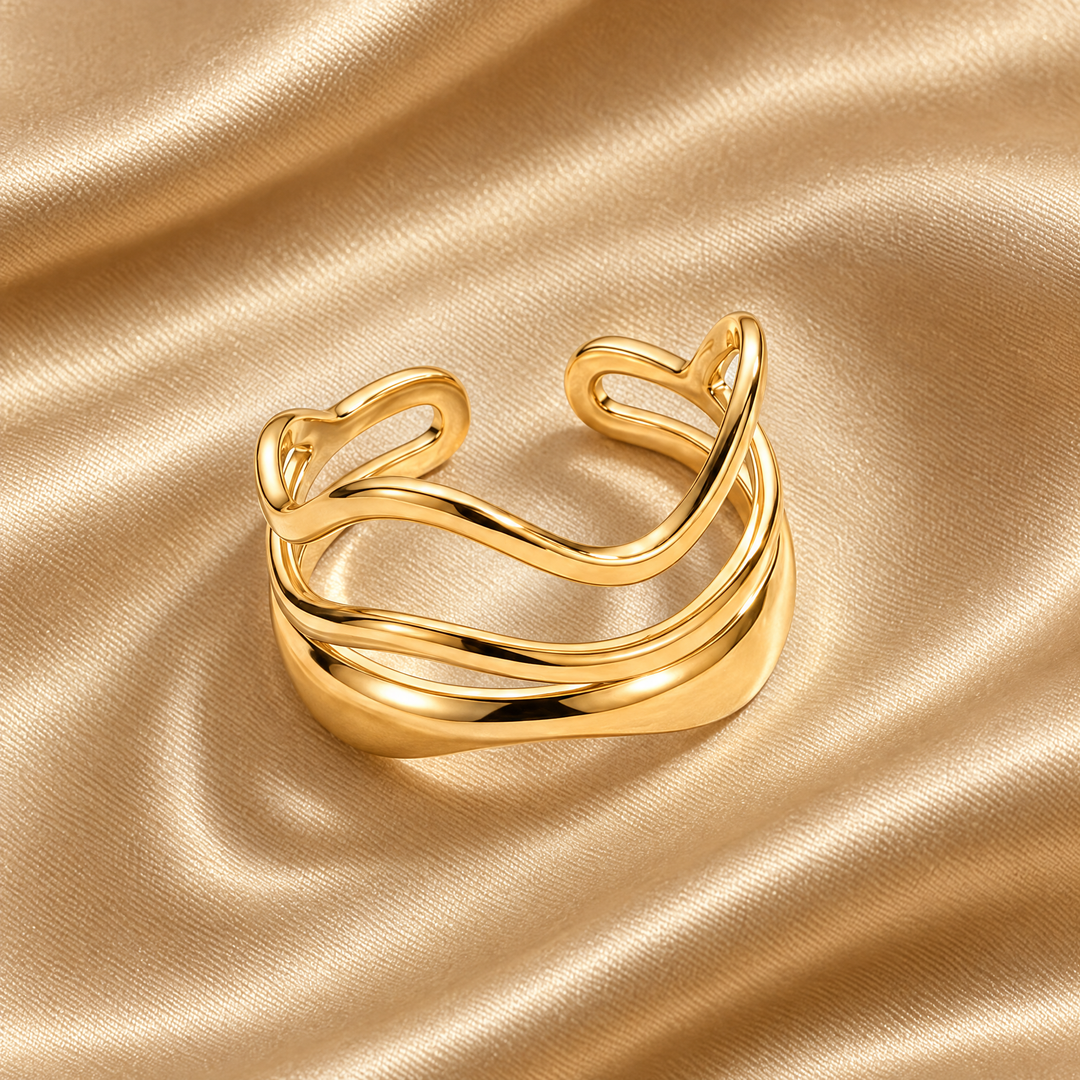 The Marlo Flow Ring resting on champagne satin
