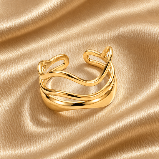 The Marlo Flow Ring resting on champagne satin