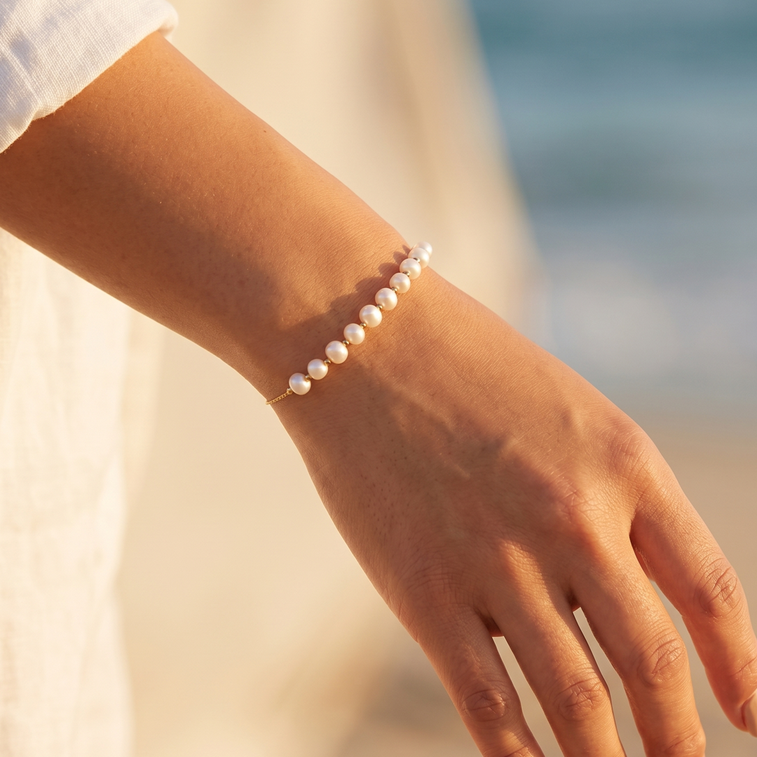 The pearl bracelet worn, seen against the light