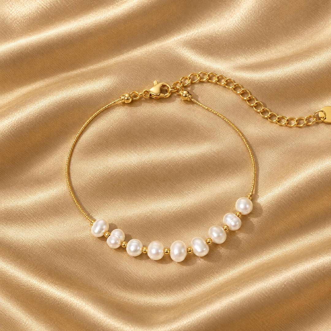 The Lumi Pearl Bracelet resting on champagne satin
