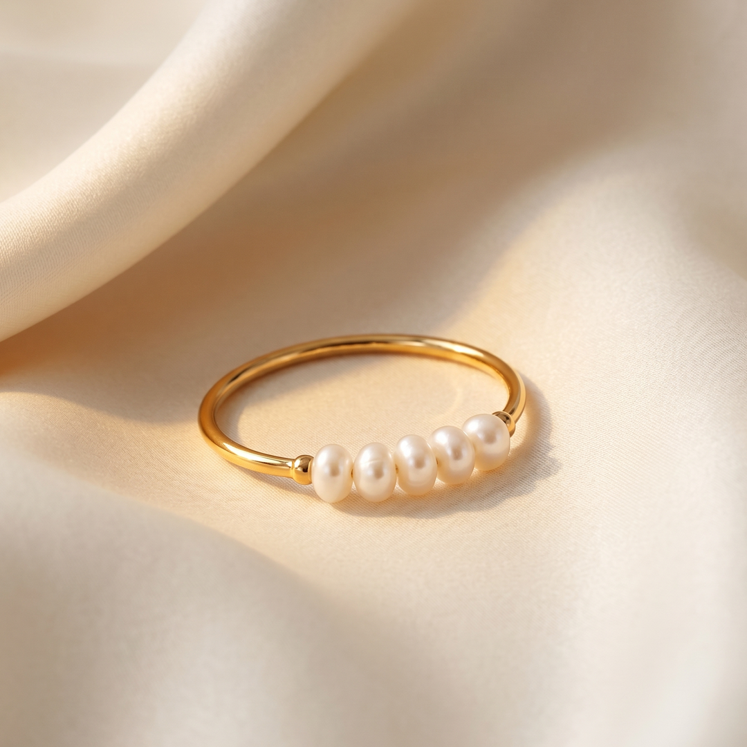 Close detail of the four pearls on the fine gold-plated band