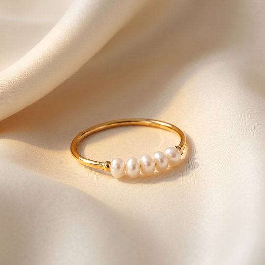 Close detail of the four pearls on the fine gold-plated band