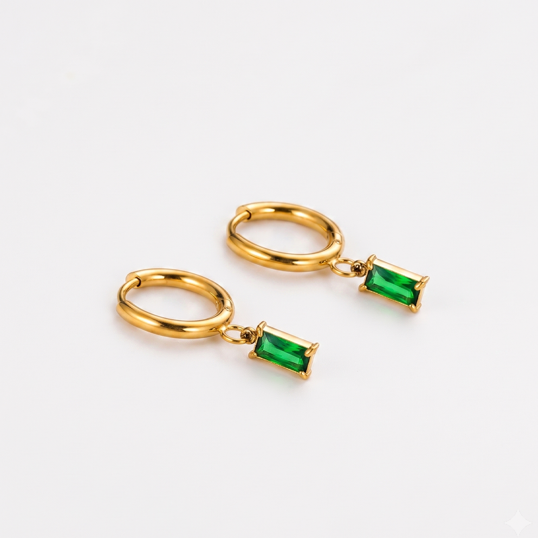A pair of gold-tone hoop earrings, each with a green rectangular crystal set at the base