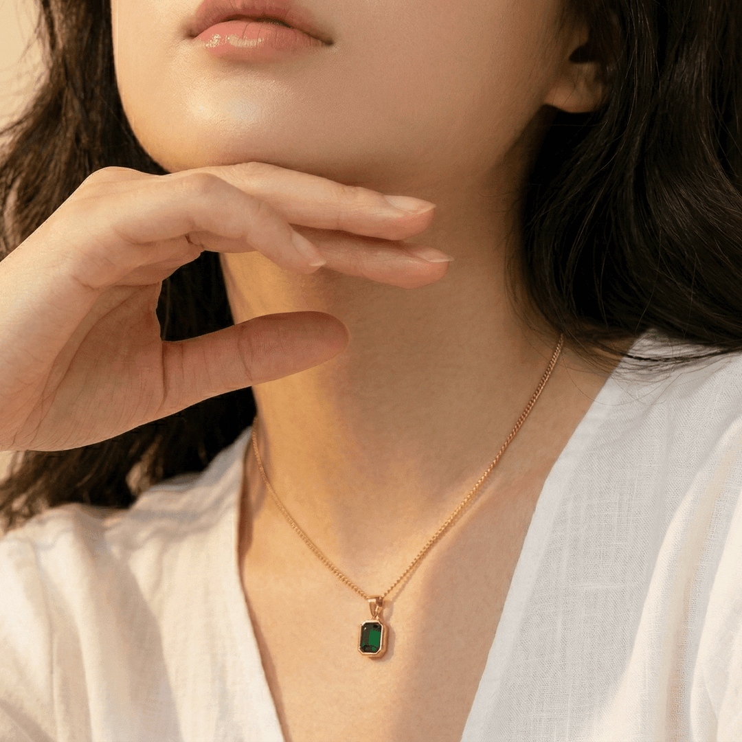 Close-up of the green pendant worn