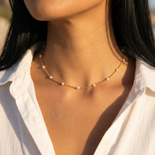 Close-up of the station necklace worn, showing the spacing of the pearls