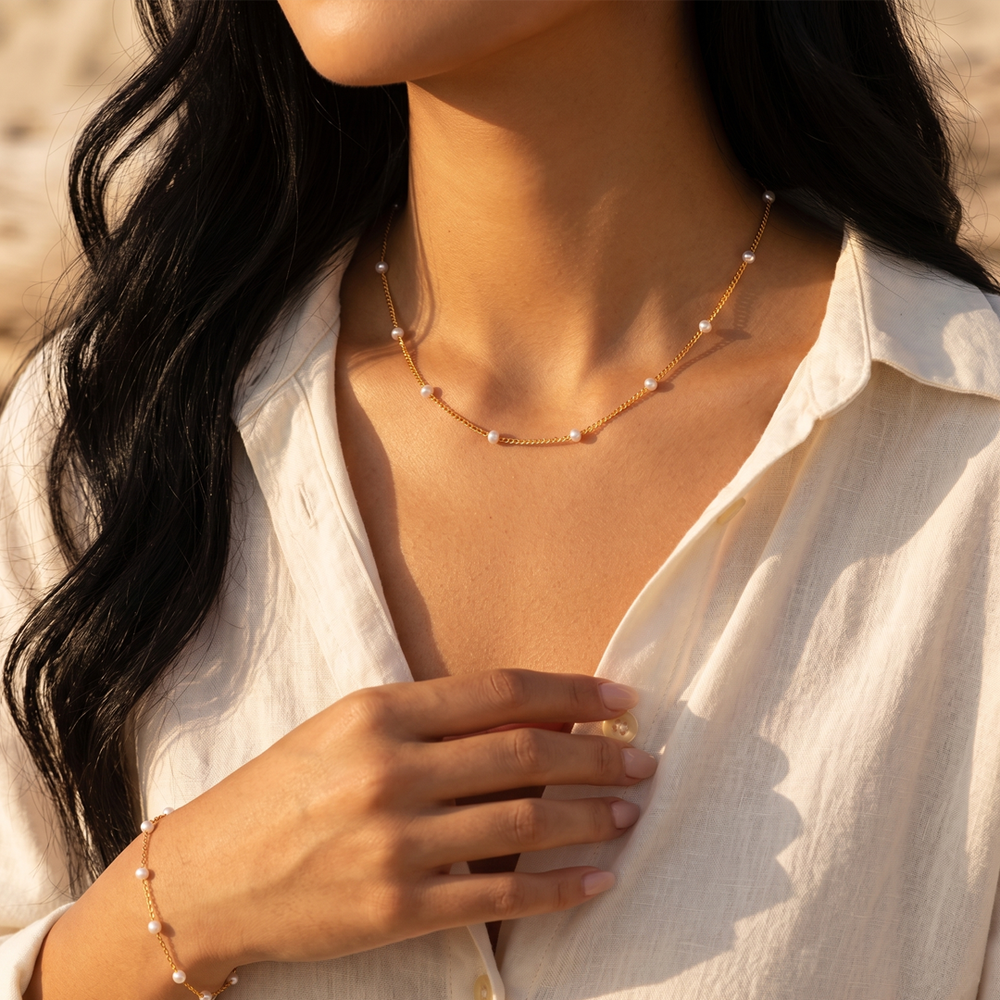 The station necklace worn, sitting just below the collarbone