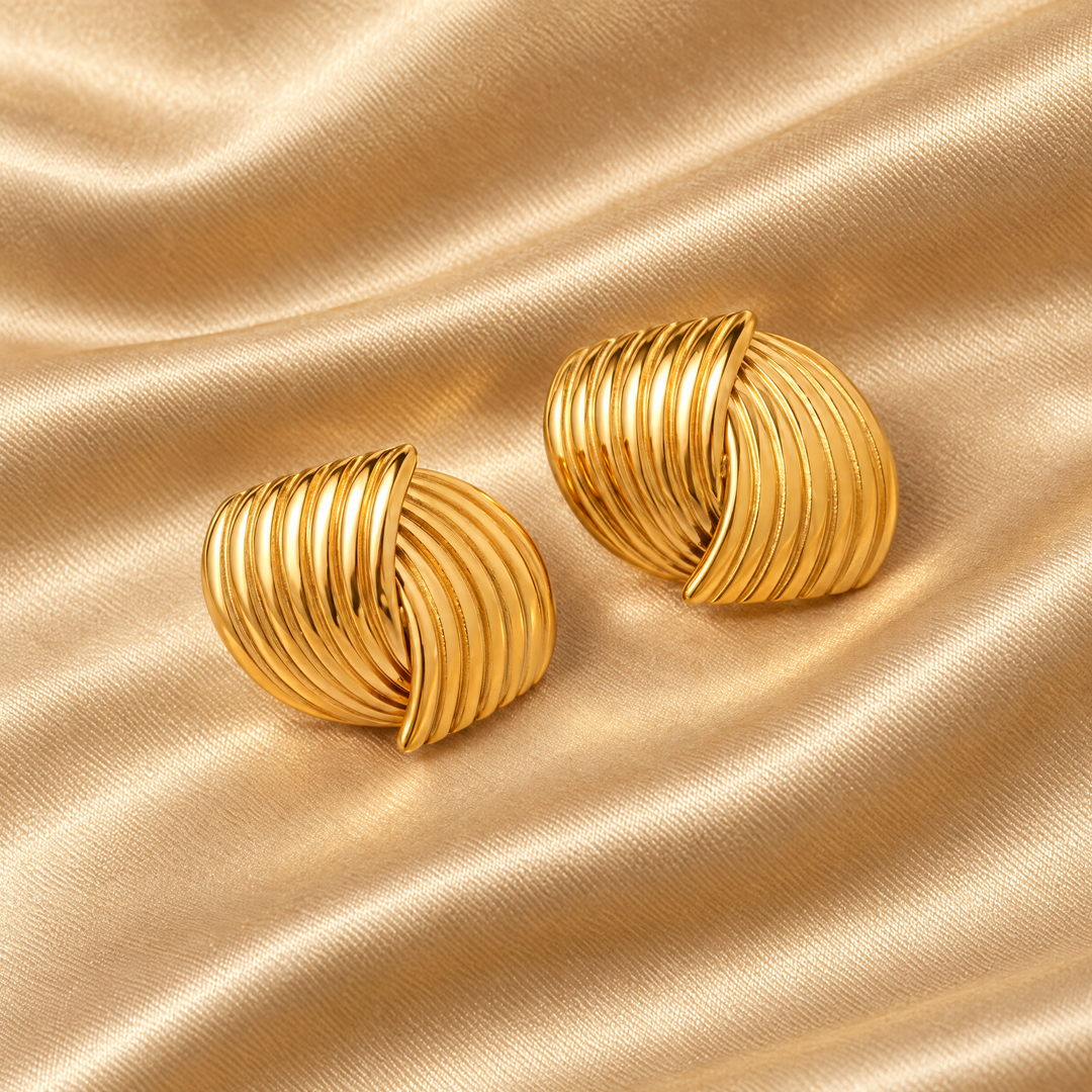 The Rae Ribbed Studs resting on champagne satin