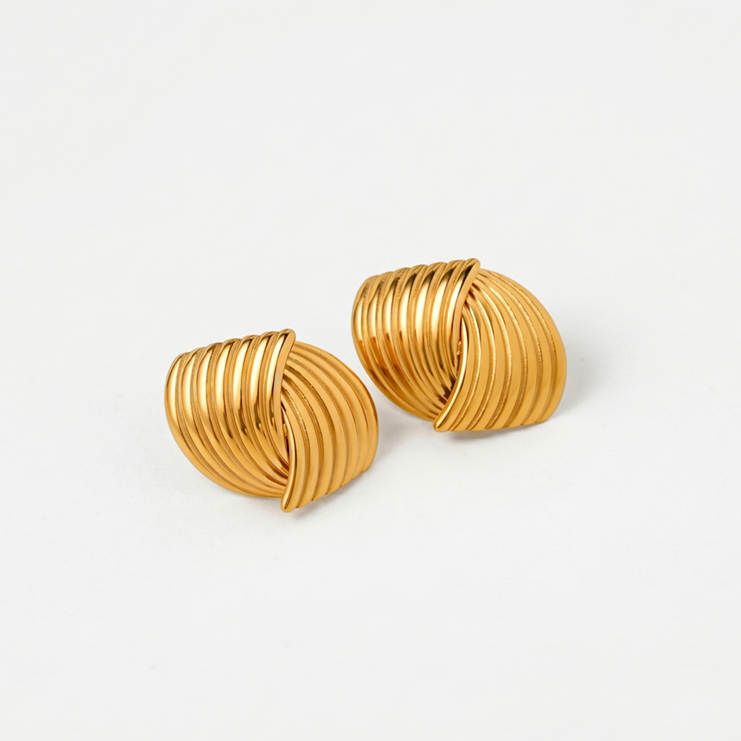 A pair of gold-tone ribbed dome stud earrings on a plain background