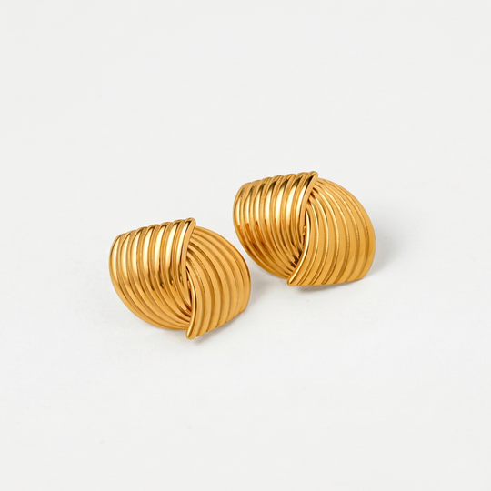 A pair of gold-tone ribbed dome stud earrings on a plain background