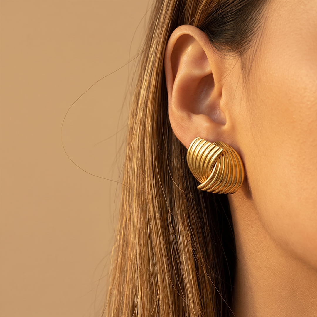 A ribbed dome stud worn, showing how it sits flat on the lobe