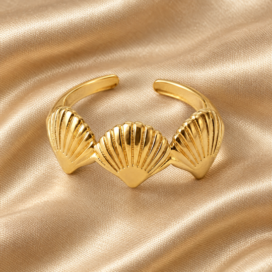 The Bay Scallop Ring resting on champagne satin