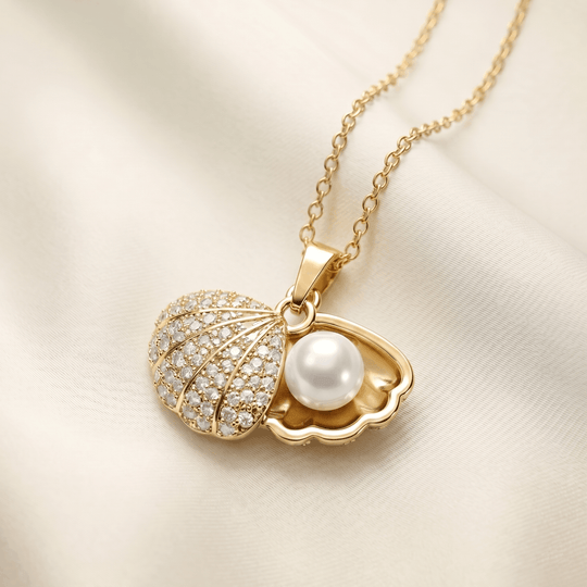 The shell pendant open, showing the pearl inside and the crystal pave