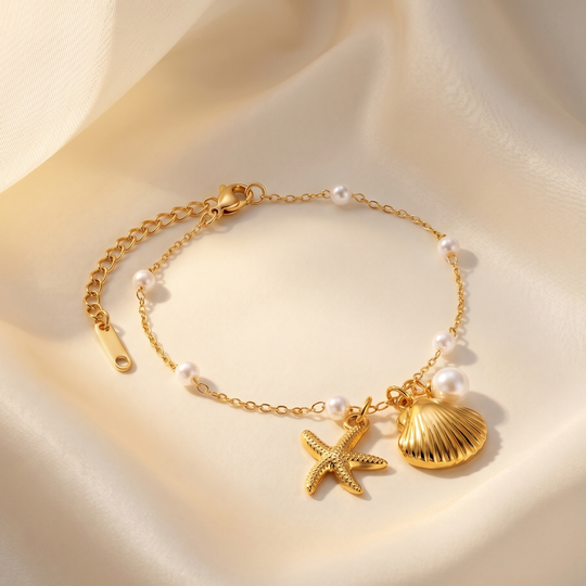 The shell and starfish bracelet resting on cream silk