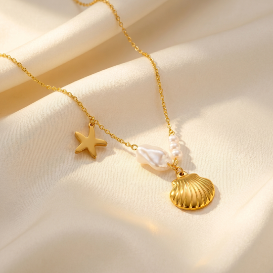 The shell, starfish and pearl charms resting on cream silk
