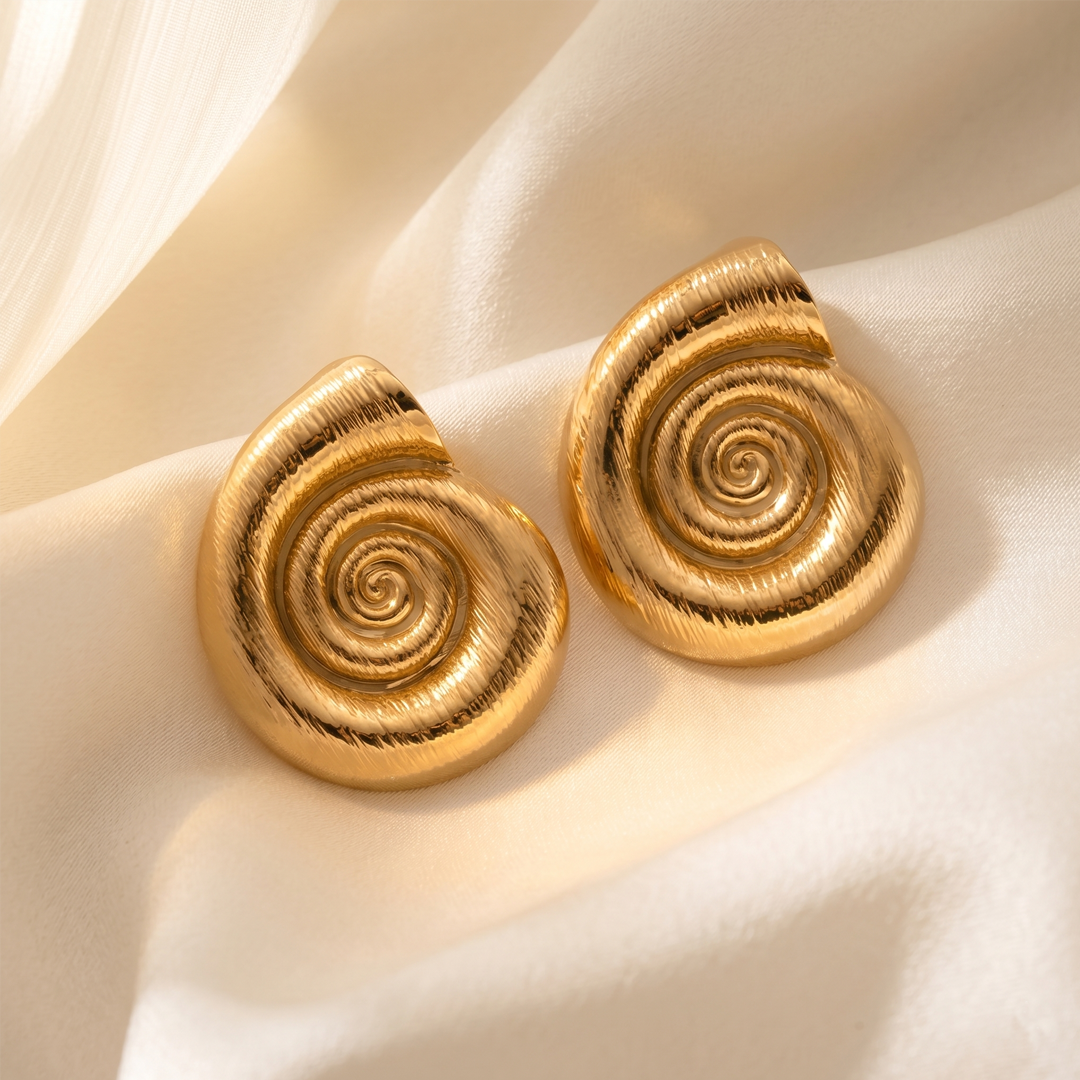 Close detail of the sculpted spiral on the gold-tone shell stud