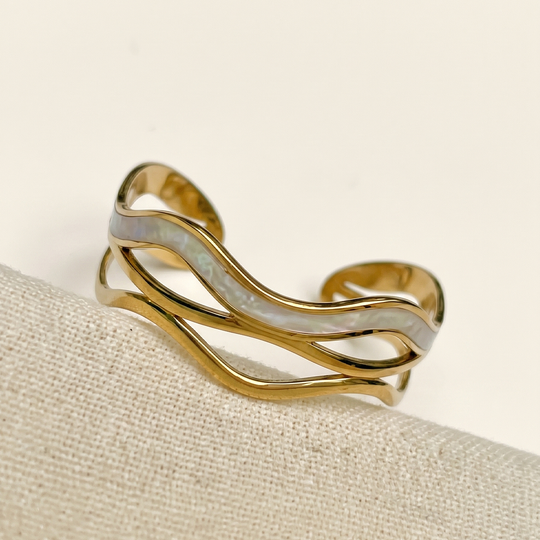 The wave cuff resting on cream silk