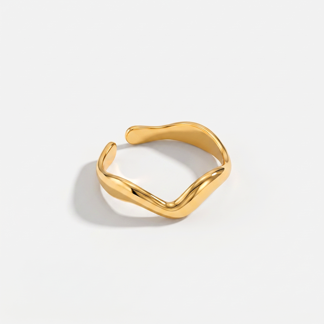 A slim gold-plated wave-shaped open ring on a plain background