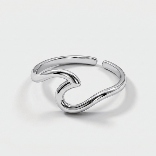The wave ring in silver-tone stainless steel, on a plain background