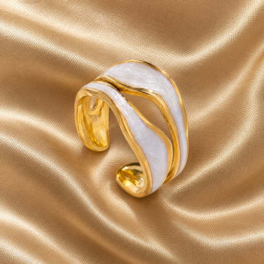 The Tide Wrap Ring resting on champagne satin