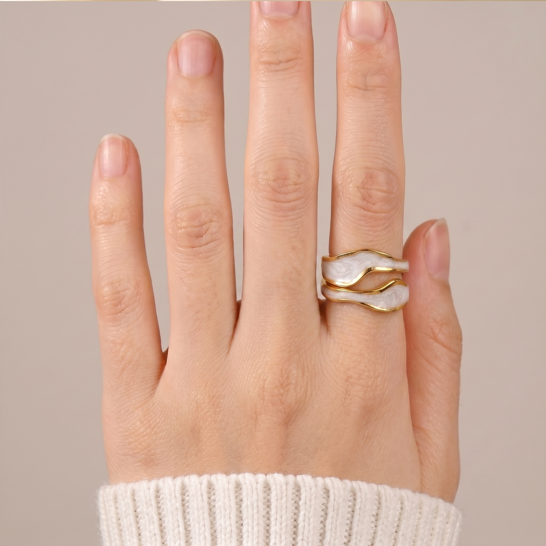 The wave wrap ring worn on the hand, showing how the band curves around the finger