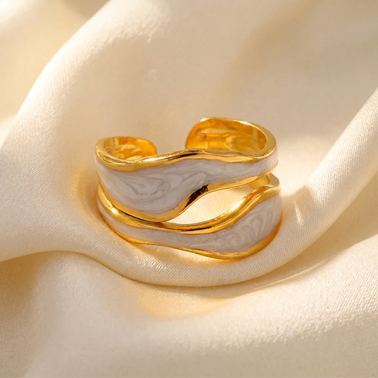 The wave wrap ring resting on cream silk