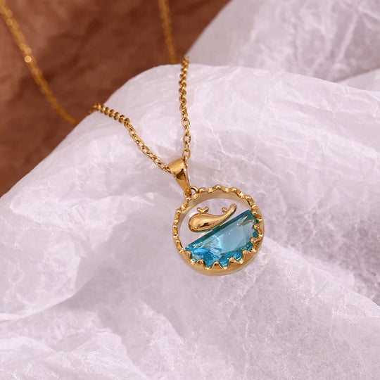 The whale pendant resting on white silk