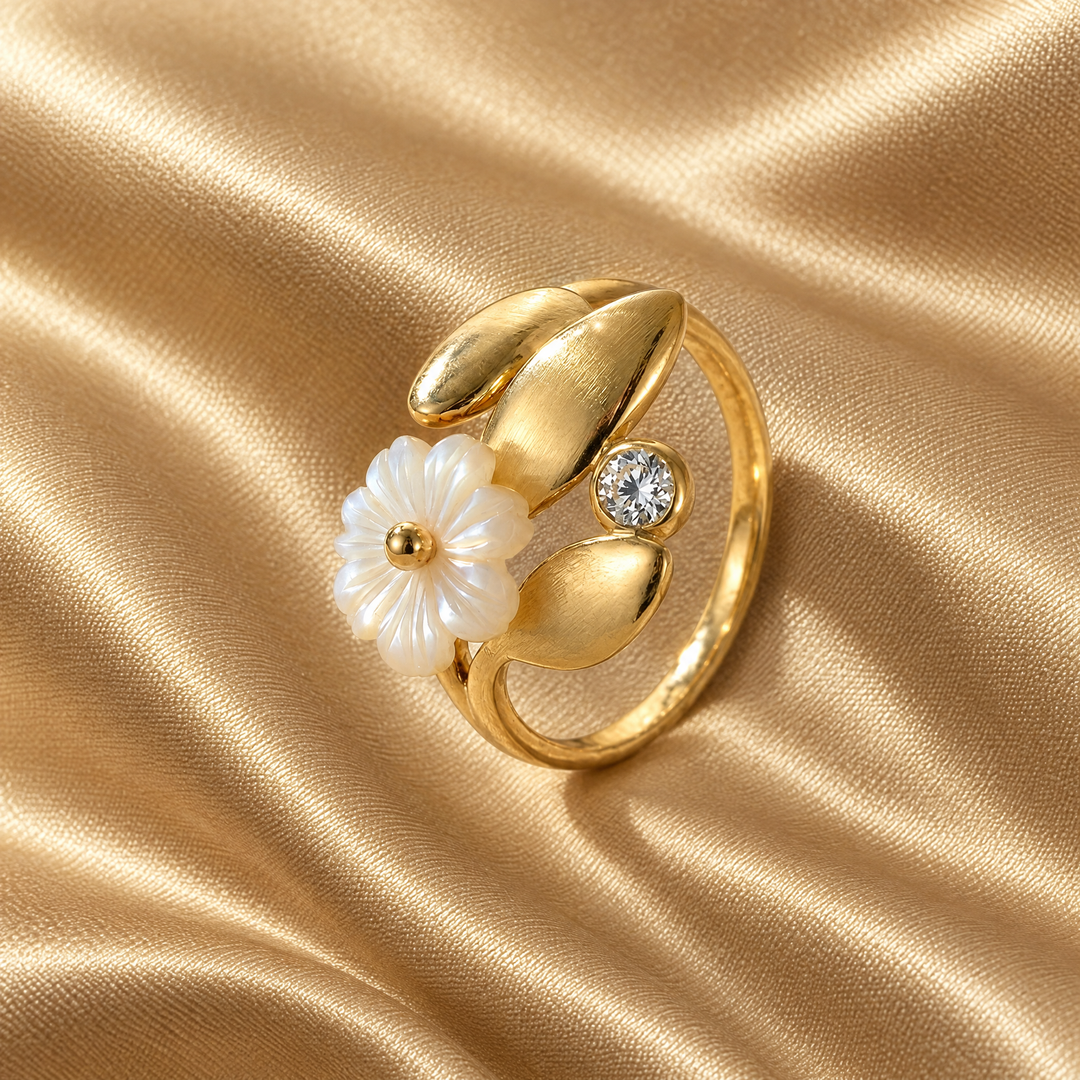 The Fleur Blossom Ring resting on champagne satin