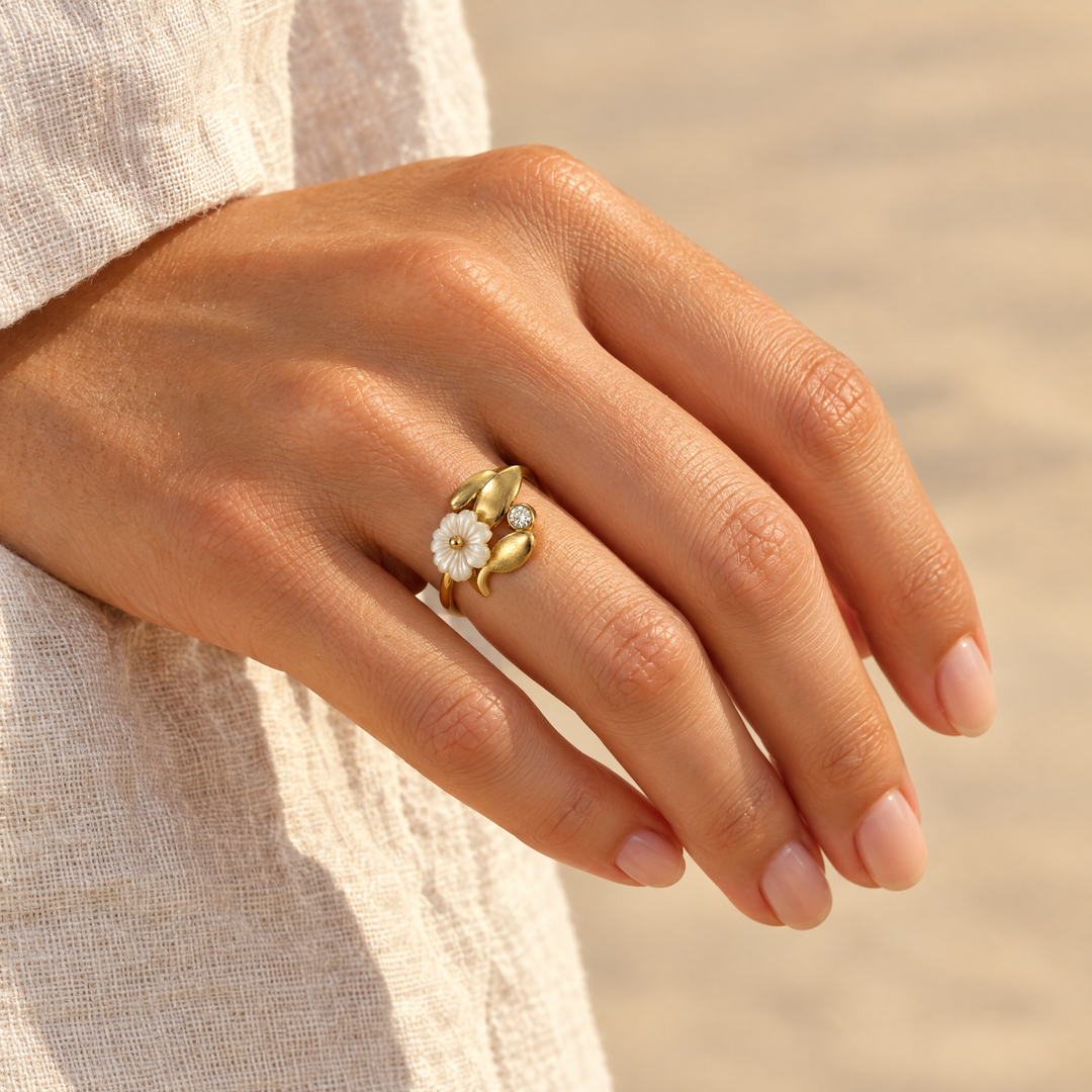 The Fleur Blossom Ring worn, seen from the side in afternoon light