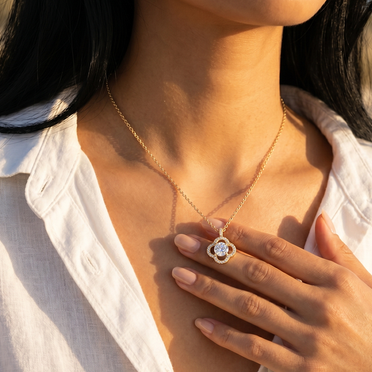 The flower pendant necklace worn, sitting just below the collarbone